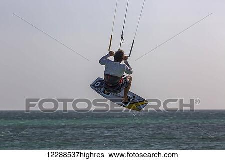 Stock Photograph - Kitesurfer catching air off Hadicurari Beach; Aruba. Fotosearch