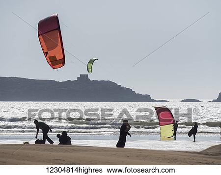 Stock Photograph - Kitesurfing off the beach; Essaouira, Morocco. Fotosearch