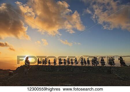 Stock Photograph - Kumu Keala Ching leads performance of Na Wai Iwi Ola on hula platform (hula pahu) at Kaana on Molokai, legendary birthplace of hula; Island of Hawaii, Hawaii, United States of America. Fotosearch
