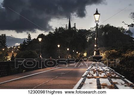 Stock Photograph - Lamp posts along a street at dusk; Newcastle, Tyne and Wear, England. Fotosearch