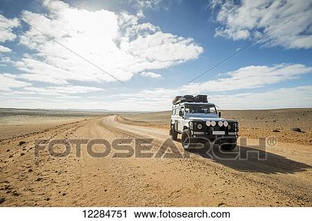 Land Rover Defender 110 driving on the road; Cape Cross, Namibia View Large Photo Image Stock Image - Land Rover Defender 110 driving on the road; Cape Cross, Namibia. Fotosearch