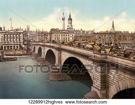 Stock Photograph - London, England. London Bridge spanning the River Thames. This late 19th century photograph shows the Victorian stone arch version of the bridge which existed from 1832 until 1968.. Fotosearch