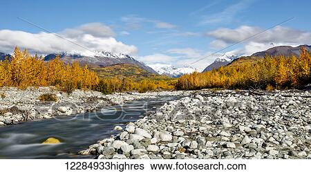 Stock Photograph - Long exposure of Granite Creek and Talkeetna Mountains along the Matanuska Valley in Southcentral Alaska, Autumn.. Fotosearch