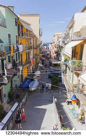 Looking down at the residences with clothes lining their balconies and a view of the shops and tourists on the streets of Manarola; Manarola, Liguria, Italy View Large Photo Image Stock Photograph - Looking down at the residences with clothes lining their balconies and a view of the shops and tourists on the streets of Manarola; Manarola, Liguria, Italy. Fotosearch