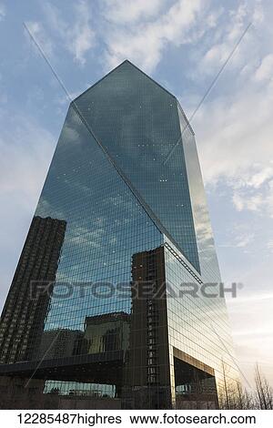 Low angle view of an office building with glass walls reflecting other buildings; Dallas, Texas, United States of America View Large Photo Image Stock Photograph - Low angle view of an office building with glass walls reflecting other buildings; Dallas, Texas, United States of America. Fotosearch