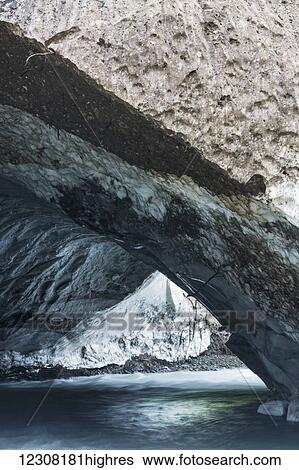 Stock Photograph - Lowe River flows through a cave in the remains of the avalanche that had closed Keystone Canyon, Valdez, Southcentral Alaska, USA, Summer. Fotosearch