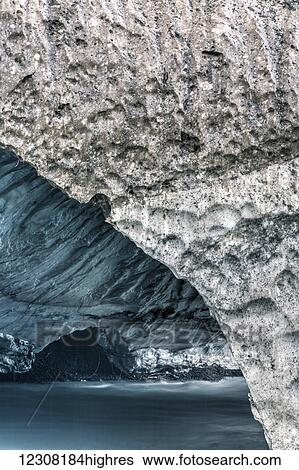 Stock Photograph - Lowe River flows through a cave in the remains of the avalanche that had closed Keystone Canyon, Valdez, Southcentral Alaska, USA, Summer. Fotosearch