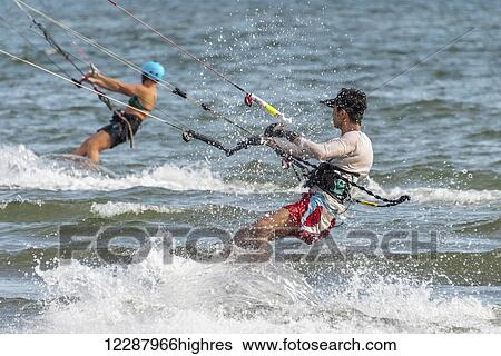 Stock Photograph - Male and female kite surfers; New Territories, Hong Kong, China. Fotosearch