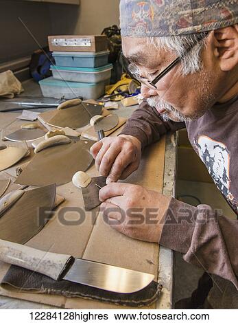 Stock Photograph - Male native artist making an Ulu, Inupiat Heritage Center, Barrow, North Slope, Arctic Alaska, USA. Fotosearch