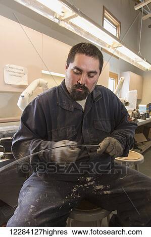 Stock Photograph - Male native artist scraping Bowhead whale baleen at the Inupiat Heritage Center, Barrow, North Slope, Arctic Alaska, USA. Fotosearch