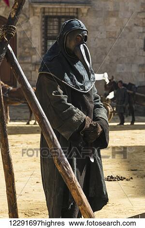 Stock Photograph - Man dressed in medieval costume with a mask to cover his face; Montepulciano, Toscana, Italy. Fotosearch