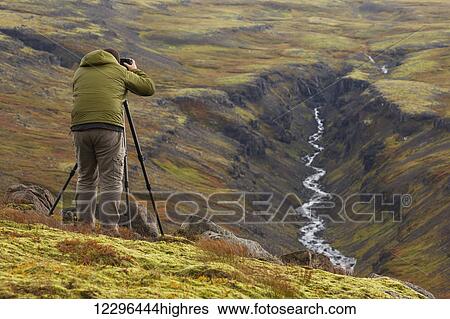 Man photographing a river valley in Iceland during autumn; Iceland View Large Photo Image Stock Photograph - Man photographing a river valley in Iceland during autumn; Iceland. Fotosearch