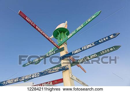 Stock Photograph - Milepost marking Barrow, Alaska, and distances to different locations around the globe, North Slope, Arctic Alaska, USA, Winter. Fotosearch