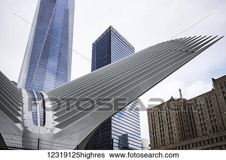 Modern structure with white prongs like wings, skyscraper and One World Trade Center; New York City, New York, United States of America View Large Photo Image Stock Photograph - Modern structure with white prongs like wings, skyscraper and One World Trade Center; New York City, New York, United States of America. Fotosearch
