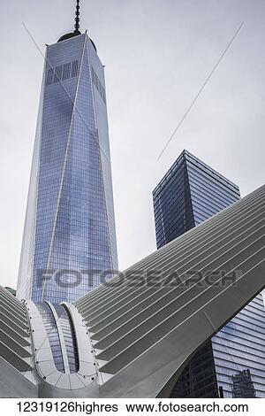 Stock Photograph - Modern structure with white prongs like wings, skyscraper and One World Trade Center; New York City, New York, United States of America. Fotosearch
