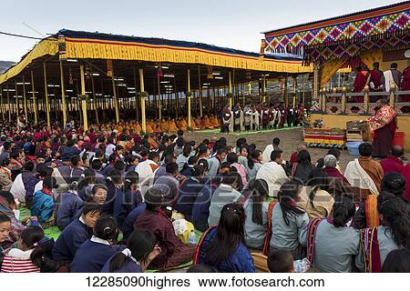 Stock Photograph - Monks and worshipers; Paro, Bhutan. Fotosearch