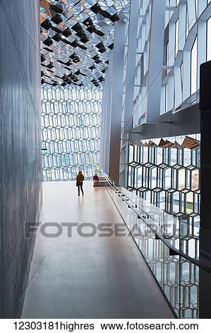 Stock Photograph - Mother and daughter explore interior of the Harpa public concert hall, designed by the Danish firm Henning Larsen Architects and the Icelandic firm Batteriao Architects, the glass facade designed by Icelandic glass artist Olafur Eliasson; Reykjavik,.... Fotosearch