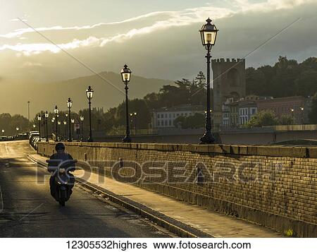 Motorcyclist on a road leading over the Arno River; Florence, Toscana, Italy View Large Photo Image Stock Photograph - Motorcyclist on a road leading over the Arno River; Florence, Toscana, Italy. Fotosearch