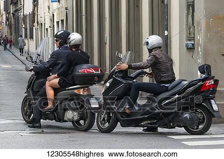 Stock Photograph - Motorcyclists on a street; Florence, Italy. Fotosearch