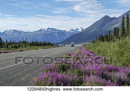 Stock Photograph - Motorhome on the Alaska Highway nearing Kluane Lake, Kluane National Park, Yukon Territory, Canada, summer. Fotosearch
