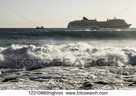 Stock Photograph - MS Pride of America, Norwegian Cruise Line vessel anchored off Kailua-Kona, Hawaii Island as surf washes on shore; Kailua-Kona, Island of Hawaii, Hawaii, United States of America. Fotosearch