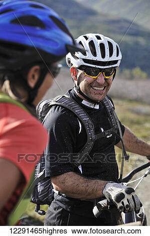 Stock Photograph - Muddy mountain bikers on the Resurrection Pass Trail in the Chugach National Forest, Kenai Peninsula, Southcentral Alaska. Fotosearch