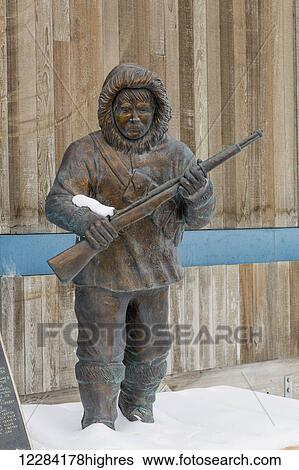Stock Photograph - Muktuk Marsten Statue outside the Piuraagvik Recreation Center, Barrow, North Slope, Arctic Alaska, USA, Winter. Fotosearch