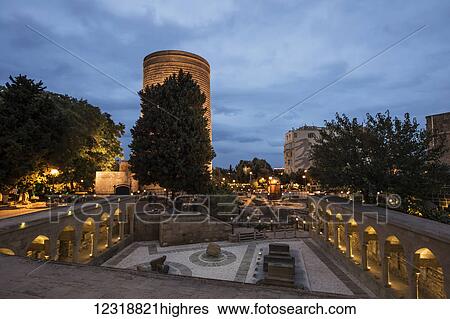 Stock Photograph - Multani Caravanserai and Maiden Tower at night; Baku, Azerbaijan. Fotosearch