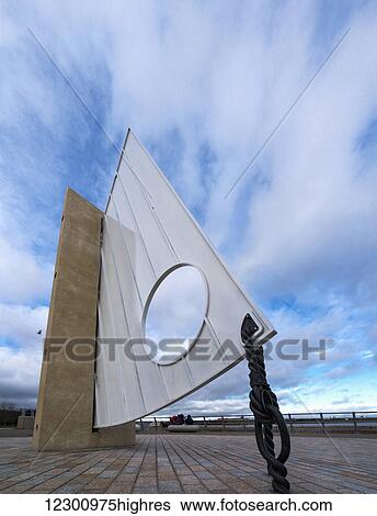 Stock Photograph - Nautical sculpture of a boat sail at the waterfront; South Shields, Tyne and Wear, England. Fotosearch