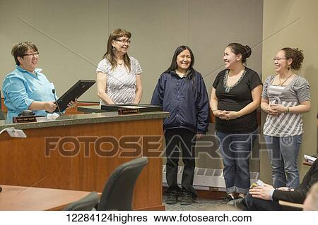 Stock Photograph - North Slope Borough assembly meeting with Mayor Charlotte Brower giving an award to a civilian, Barrow, North Slope, Arctic Alaska, USA. Fotosearch