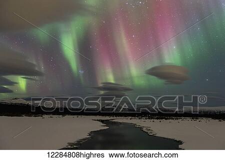 Stock Photograph - Northern Lights over open water in winter near Whitehorse, Yukon Territory, Canada. Fotosearch