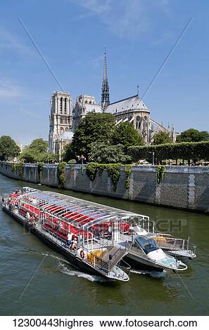 Notre Dame and a boat on the River Seine; Paris, France View Large Photo Image Stock Photograph - Notre Dame and a boat on the River Seine; Paris, France. Fotosearch