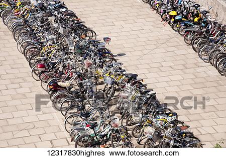 Stock Photograph - Numerous bicycles parked in a row at a Secondary school at Shenhaiguan on the Great Wall of China; Shenhaiguan, China. Fotosearch