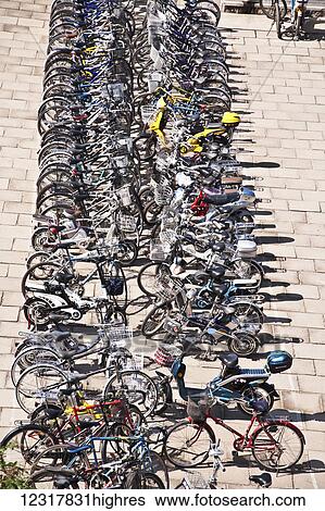 Stock Photograph - Numerous bicycles parked in a row at a Secondary school at Shenhaiguan on the Great Wall of China; Shenhaiguan, China. Fotosearch
