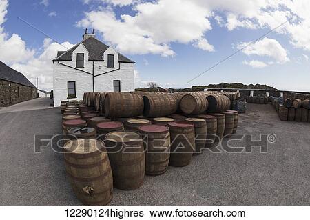 Stock Photograph - Numerous wooden barrels outside in a lot; Isle of Islay, Scotland. Fotosearch