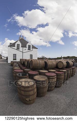 Stock Photograph - Numerous wooden barrels outside in a lot; Isle of Islay, Scotland. Fotosearch