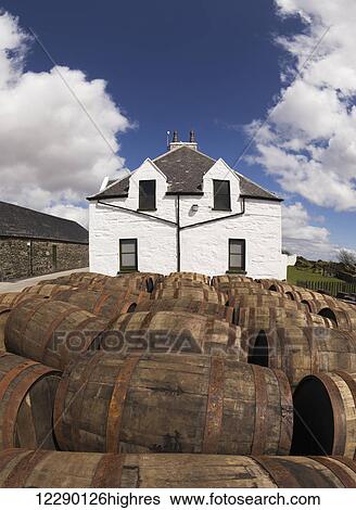 Stock Photograph - Numerous wooden barrels outside in a lot; Isle of Islay, Scotland. Fotosearch
