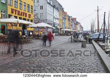 Stock Photograph - Nyhavn is the famous waterfront canal in Copenhagen, with colourful seventeenth and eighteenth century townhomes lining the canal; Copenhagen, Denmark. Fotosearch