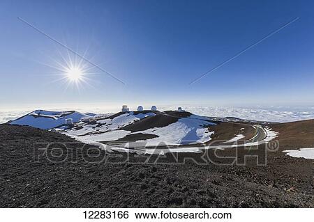 Stock Photograph - Observatories, including twin Kecks, atop Mauna Kea, tallest mountain in Hawaii and some of the best astronomical viewing conditions in the world; Island of Hawaii, Hawaii, United States of America. Fotosearch