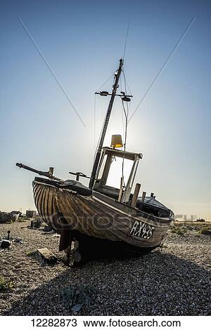 Old boat on a shingle beach; Dungeness, Kent, England View Large Photo Image Stock Image - Old boat on a shingle beach; Dungeness, Kent, England. Fotosearch