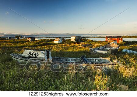 Stock Photograph - Old boats and shacks at the fish camp on the Newhalen River near the village of Newhalen in the Bristol Bay region of Alaska.. Fotosearch
