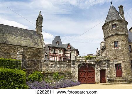 Old stone castle turret and church with large wooden gates in stone wall with blue sky and clouds; Josseline, Brittany, France View Large Photo Image Stock Image - Old stone castle turret and church with large wooden gates in stone wall with blue sky and clouds; Josseline, Brittany, France. Fotosearch