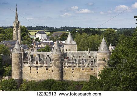 Old stone castle with large turrets and church steeple in the background with blue sky and clouds; Josseline, Brittany, France View Large Photo Image Stock Image - Old stone castle with large turrets and church steeple in the background with blue sky and clouds; Josseline, Brittany, France. Fotosearch
