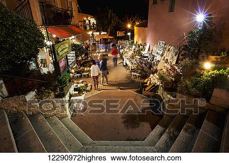 Stock Photograph - Open air market at nighttime; San Teodoro, Sardinia, Italy. Fotosearch