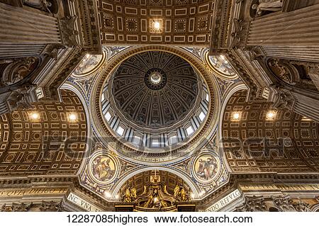 Stock Photograph - Ornate ceiling above the Papal altar, St. Peter's Basilica; Rome, Italy. Fotosearch