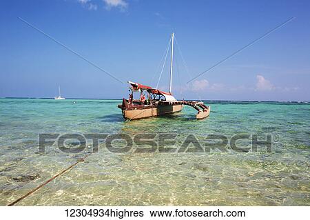 Stock Photograph - Outrigger canoe at Waimanalo Beach; Oahu, Hawaii, United States of America. Fotosearch