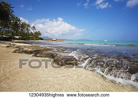 Stock Photograph - Outrigger canoe at Waimanalo Beach; Oahu, Hawaii, United States of America. Fotosearch