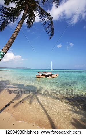 Stock Photograph - Outrigger canoe at Waimanalo Beach; Oahu, Hawaii, United States of America. Fotosearch