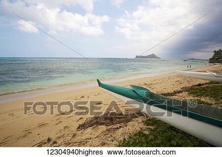 Stock Photograph - Outrigger canoe on Waimanalo Beach; Waimanalo, Oahu, Hawaii, United States of America. Fotosearch