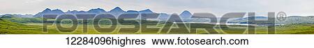 Stock Photograph - Panorama of two wind turbines sit above the city of Sand Point, Sand Point, Popof Island, Southwestern Alaska, USA, Summer. Fotosearch